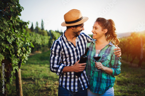 Picture of people tasting red wine in vineyard