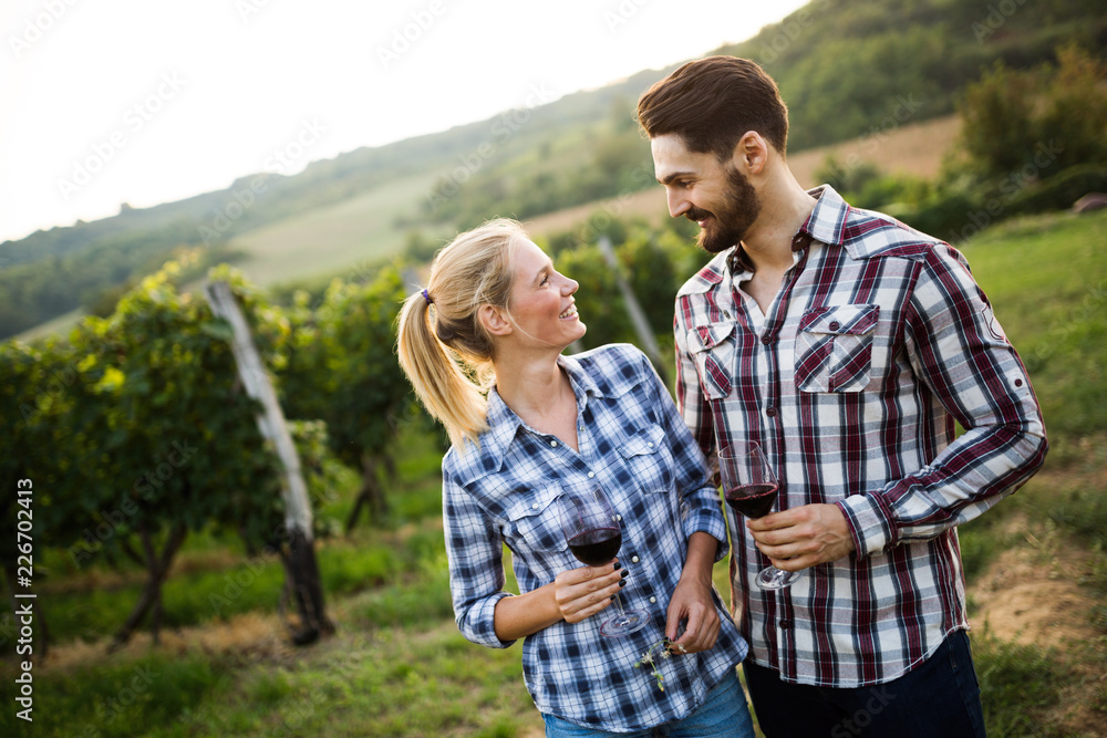 Wine tourists tasting wine in vineyard Wine tourists tasting wine in vineyard