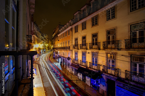 Night Lights Motion Blur over Cobblestone Street of Lisbon Portugal