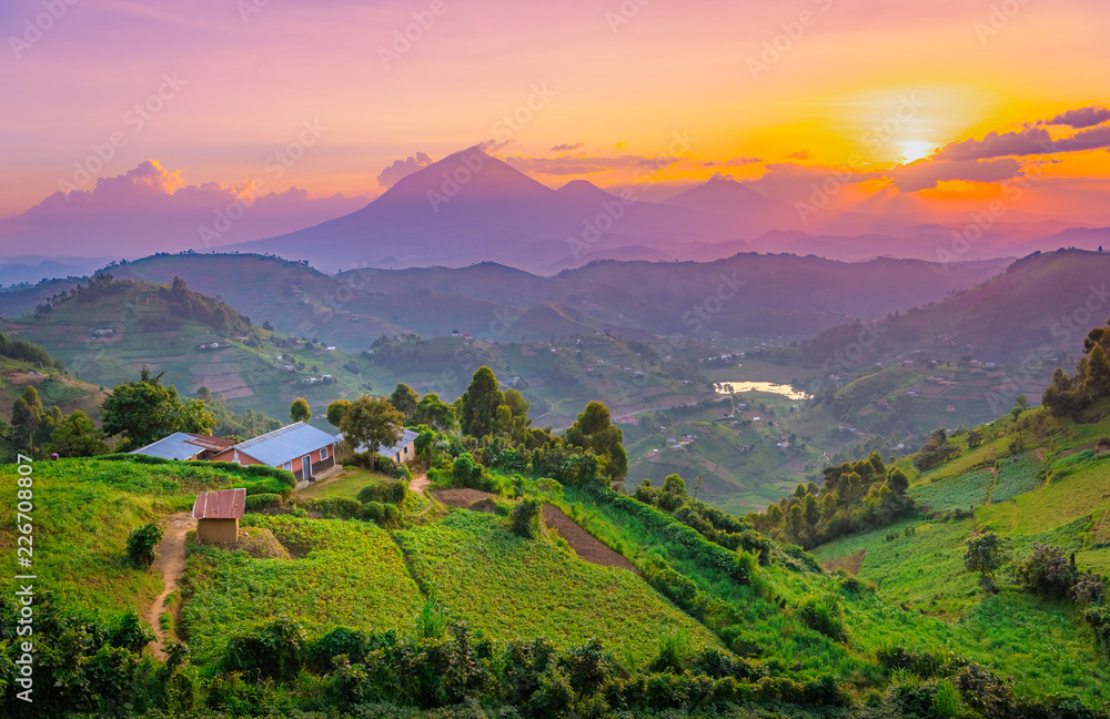 Kisoro Uganda beautiful sunset over mountains and hills of pastures and farms in villages of Uganda. Amazing colorful sky and incredible landscape to travel and admire the beauty of nature in Africa