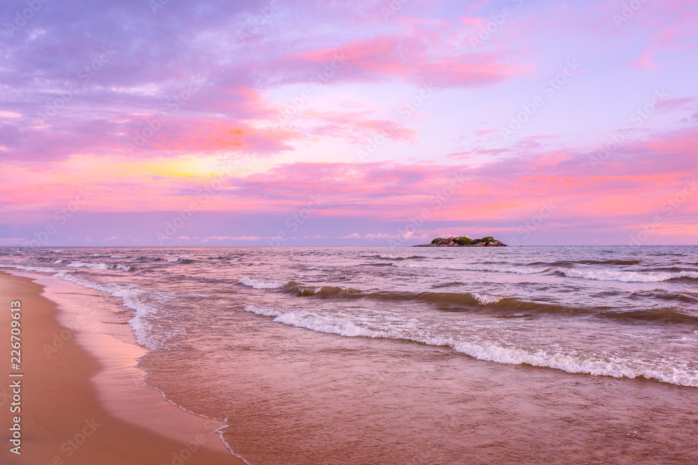 Pink sunset on lake beach sea sand beautiful colors in the sky clouds with  island in the distance, Lake Malawi, Malawi, Africa Stock Photo