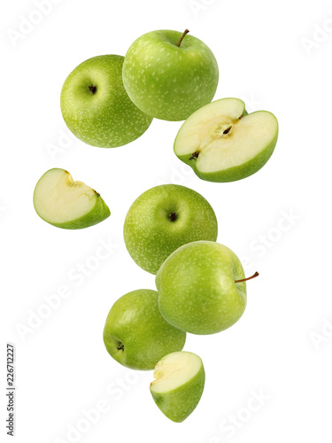 Falling green apples isolated on white.