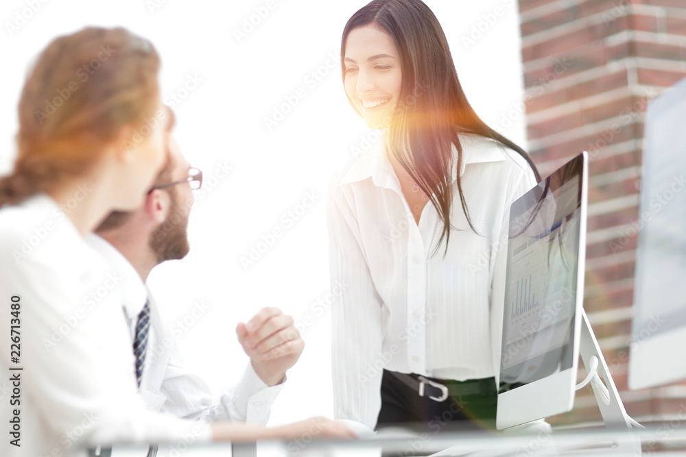 young business woman talking to colleagues in the office young business woman talking to colleagues in the office