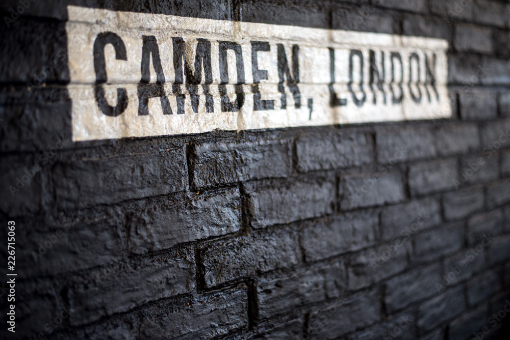 Camden, London white text on a black brickwall. Camden, London white text on a black brickwall.