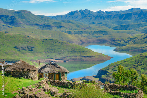 Lesotho traditional hut house homes in Lesotho village in Africa. Beautiful scenic landscape of village in daytime with typical huts built by villagers by the lake of Mohale Dam photo