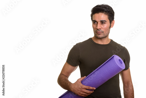 Young handsome Persian man against white background