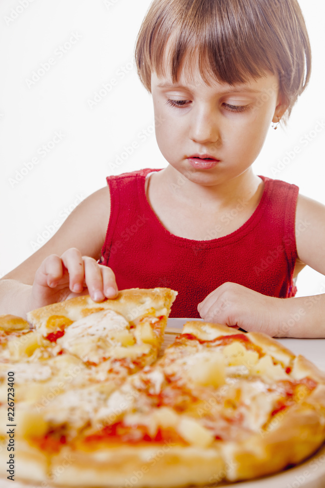 Time to eat! Cute little funny girl  with a big pizza on a white background. Happy child having fun eating dinner.