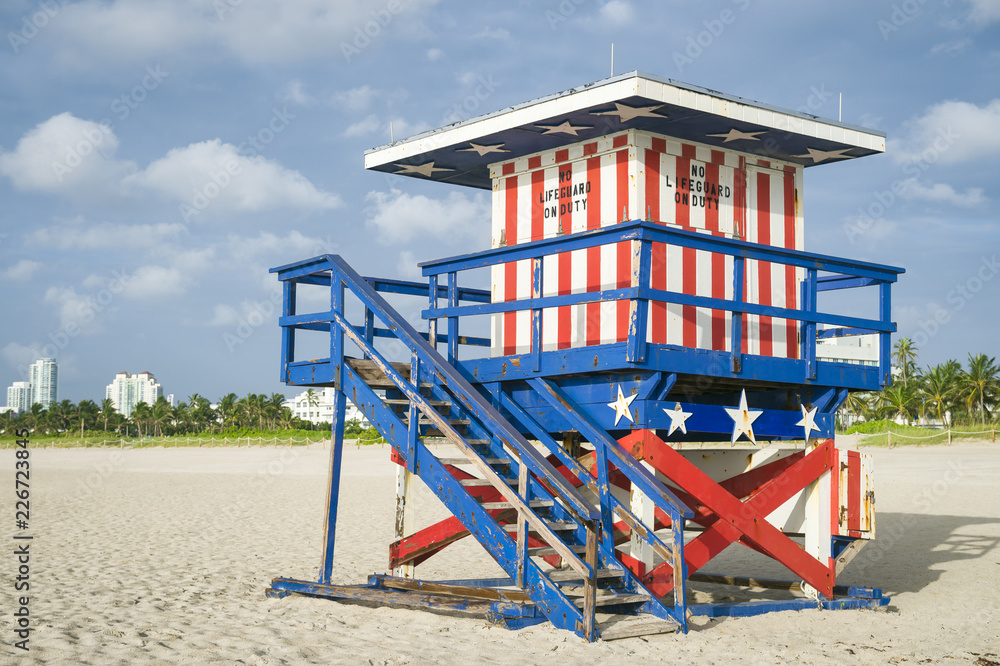 Classic red, white, and blue American flag themed lifeguard tower on the sand in South Beach, Miami, Florida, USA Classic red, white, and blue American flag themed lifeguard tower on the sand in South Beach, Miami, Florida, USA