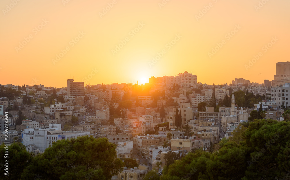 Amman, Jordan its Roman ruins in the middle of the ancient citadel park in the center of the city. Sunset on Skyline of Amman and old town of the city with nice view over historic capital of Jordan.