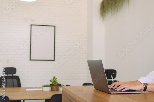 Wallpaper Mural Closeup image of woman's hands using and typing on laptop keyboard on wooden table in office Torontodigital.ca