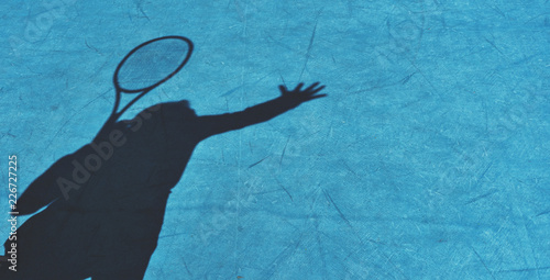 Shadow of woman tennis player, serving the ball