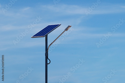 LED street light with solar cell and blue sky background.