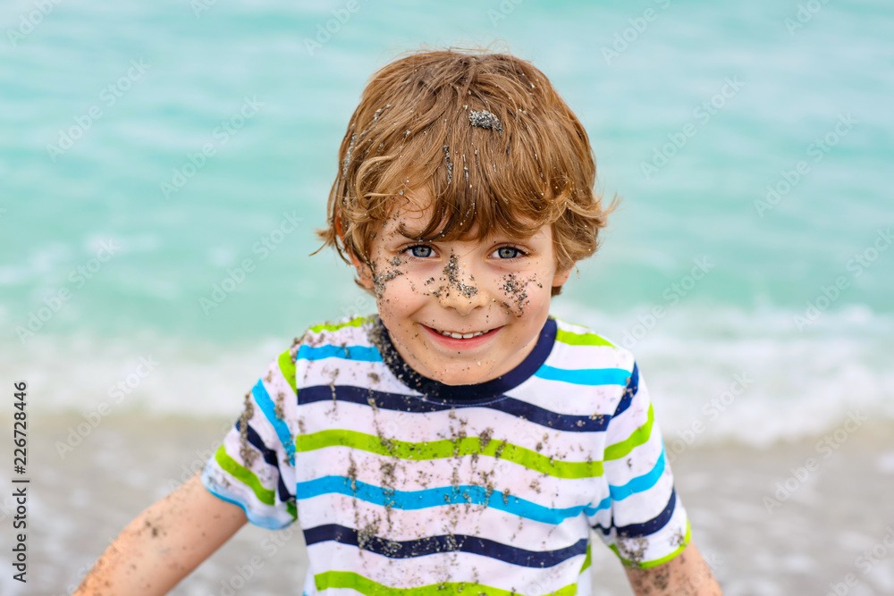Little kid boy having fun on tropical beach Little kid boy having fun on tropical beach