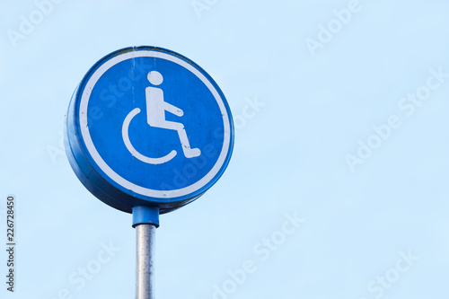 Disabled Badge Holders Only at Car Park Sign Post in Blank Blue Sky