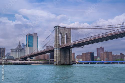 Brooklyn Bridge in New York City at clounds sky, Skyline of downtown New York, USA