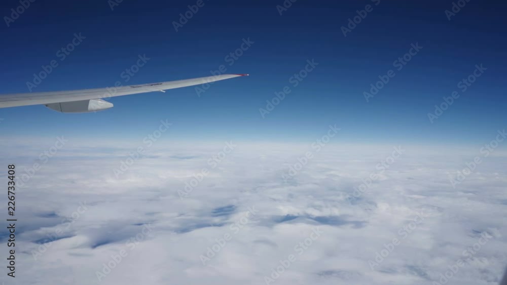 Clouds, sun, sky as seen through window of an aircraft Clouds, sun, sky as seen through window of an aircraft