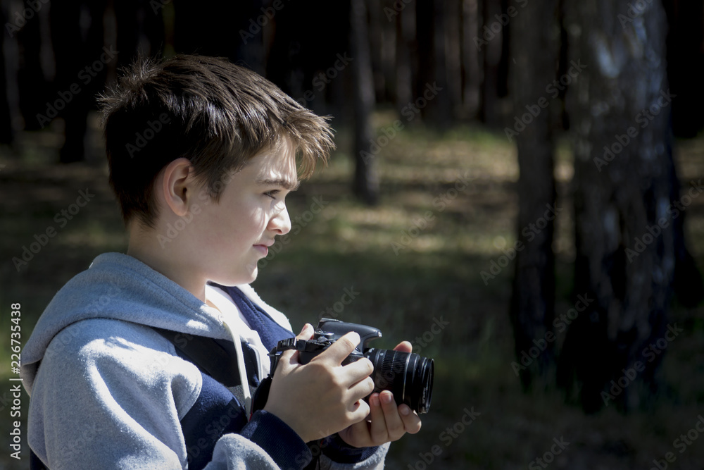 Portrait of a young photographer shooting a landscape Portrait of a young photographer shooting a landscape
