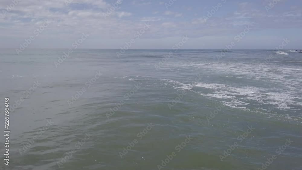 Breaking wave at low flight over water Breaking wave at low flight over water