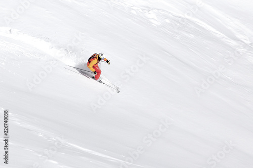 One skier skiing downhill through fresh powder snow, no sky, white snow background