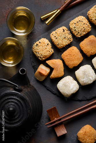 Mochi assortment with chopticks and tea traditional japanese rice dessert top view photo