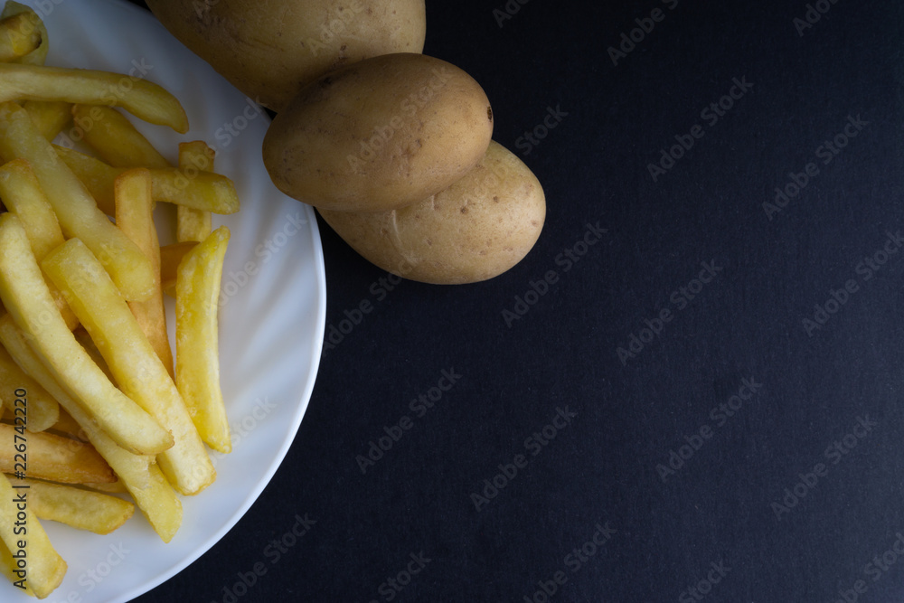 Potato fry on dark background with selective focus and crop fragment