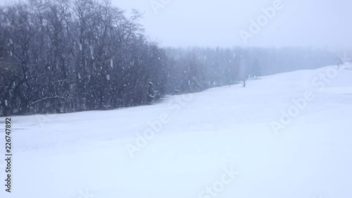 Snowfall in a white snow covered landscape