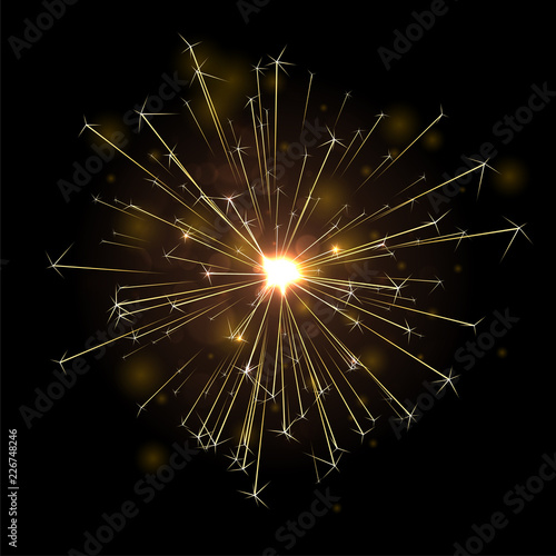 Golden shiny firework or sparkler on black background.