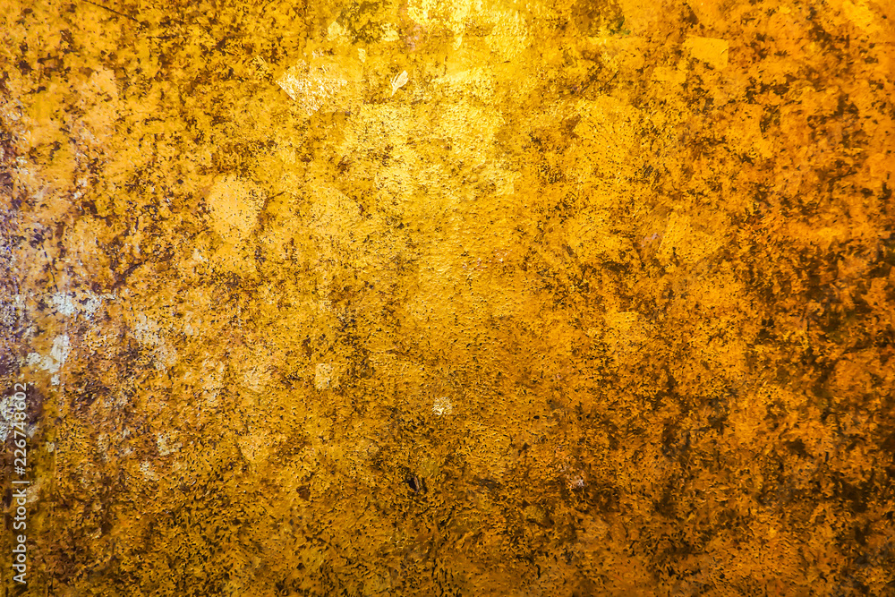 Gold and back abstract background with color shift from light to dark.