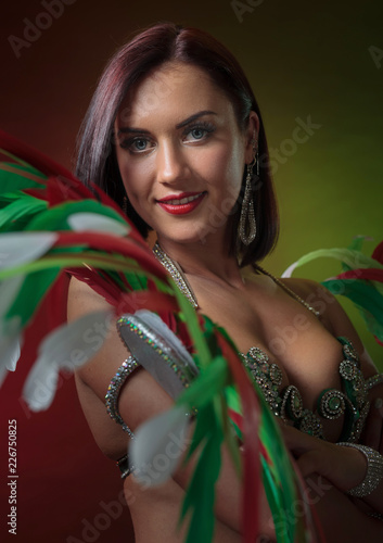 Photography Beautiful  woman in carnival costume with rhinestones and natural feathers