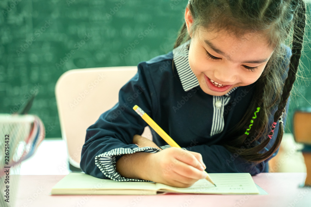 asian primary school student studying homework in classroom. asian primary school student studying homework in classroom.