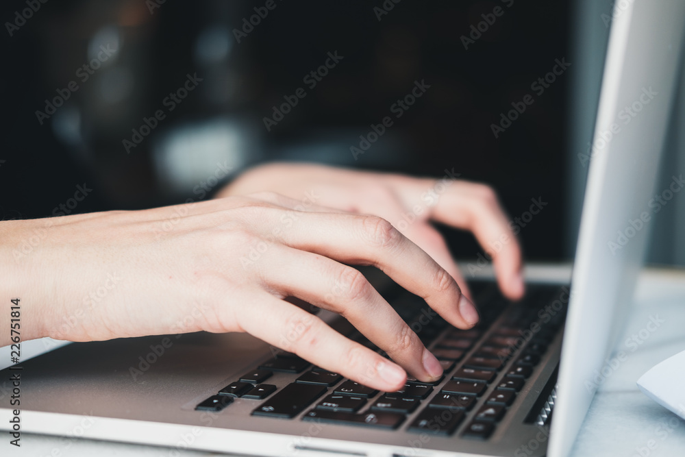 Closeup of woman’s hands working on laptop at office. Business woman concept. Horizontal