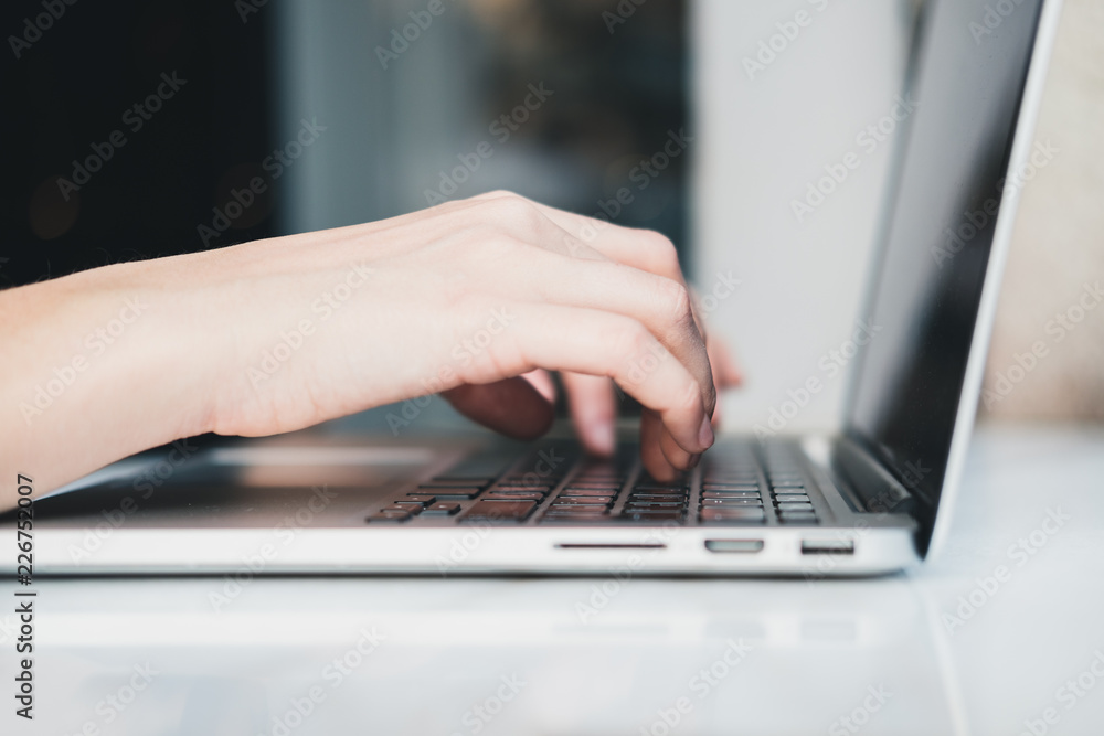 Closeup of woman’s hands typing on laptop at cafe outdoors. Freelance concept. Horizontal Closeup of woman’s hands typing on laptop at cafe outdoors. Freelance concept. Horizontal