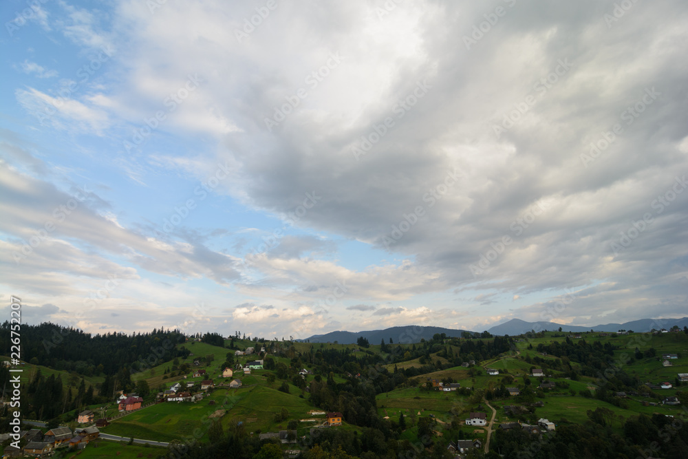 Landscape area (village houses, firs, pines, trees, mountains, hills, sunset). Nature and man. Natural background. Landscape area (village houses, firs, pines, trees, mountains, hills, sunset). Nature and man. Natural background.