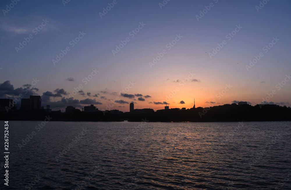 Cityline sunset over water, Ohori park, Fukuoka, Japan