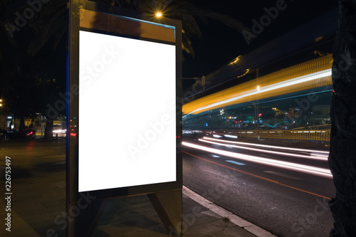 White advertisement lightbox at night. Commercial mock-up. Horizontal. Blank space for content in a city. 