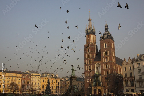 Main Market Square of Old Town of Krakow with Saint Mary's Basilica and Adam Mickiewicz Monument
