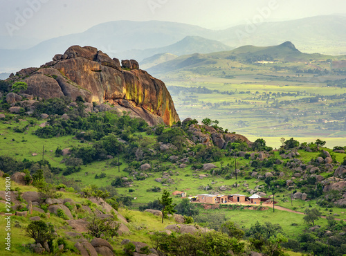 Ezulwini valley in Swaziland with beautiful mountains, trees and rocks in scenic green valley between Mbabane and Manzini cities. Traditional huts houses of Swaziland