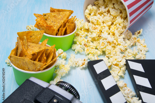 scattered popcorn and two buckets of nachos, next to the video camera and take to stop and continue shooting