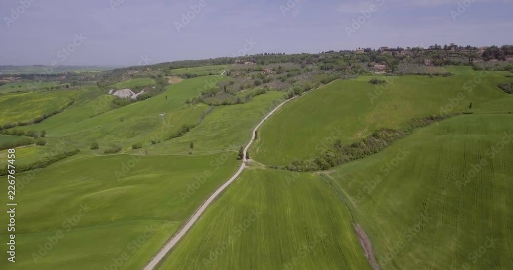 Aerial, beautiful green hills and fields and cypresses landscape in Val d’Orcia in Tuscany, Italy Aerial, beautiful green hills and fields and cypresses landscape in Val d’Orcia in Tuscany, Italy