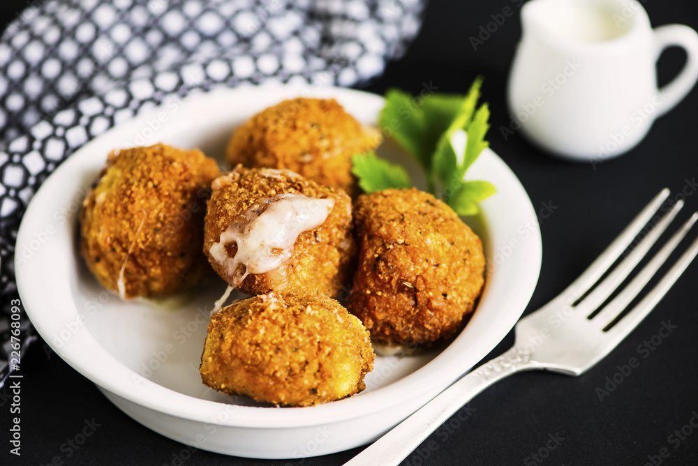fried cheese balls with mozzarella on a plate