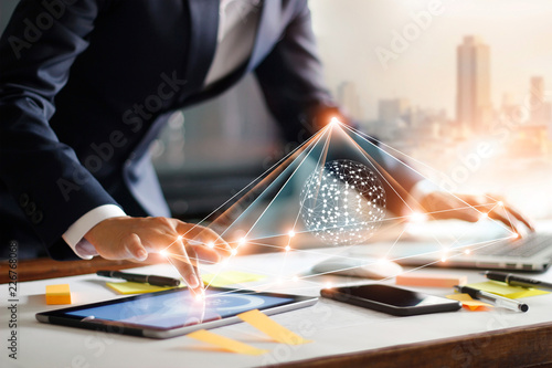 Businessman touching tablet and laptop. Managing global structure networking and data exchanges customer connection on workplace. Business technology and digital marketing.