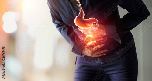 Woman touching stomach painful suffering from stomachache causes of menstruation period, gastric ulcer, appendicitis or gastrointestinal system disease. Healthcare and health insurance concept photo