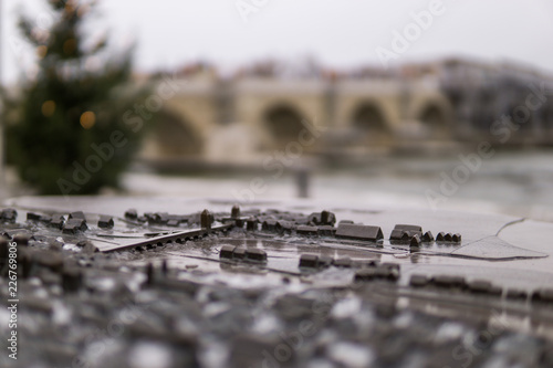 Miniature of the ancient bridge Steinbruecke in Regensburg with the real bridge blurred in the background. photo