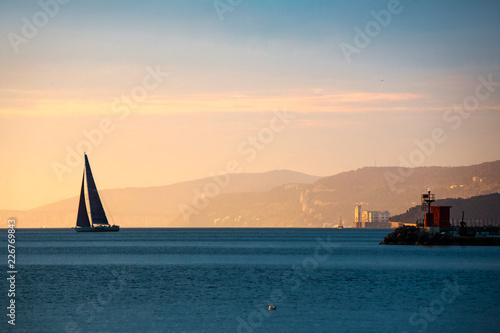 Boat sailing at sunset