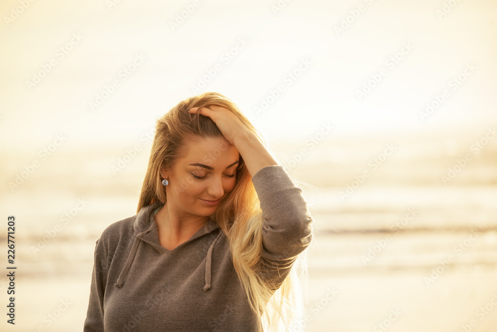 Tender girl on a light natural background of the sea coast.
Tender girl on a light natural background of the sea coast.