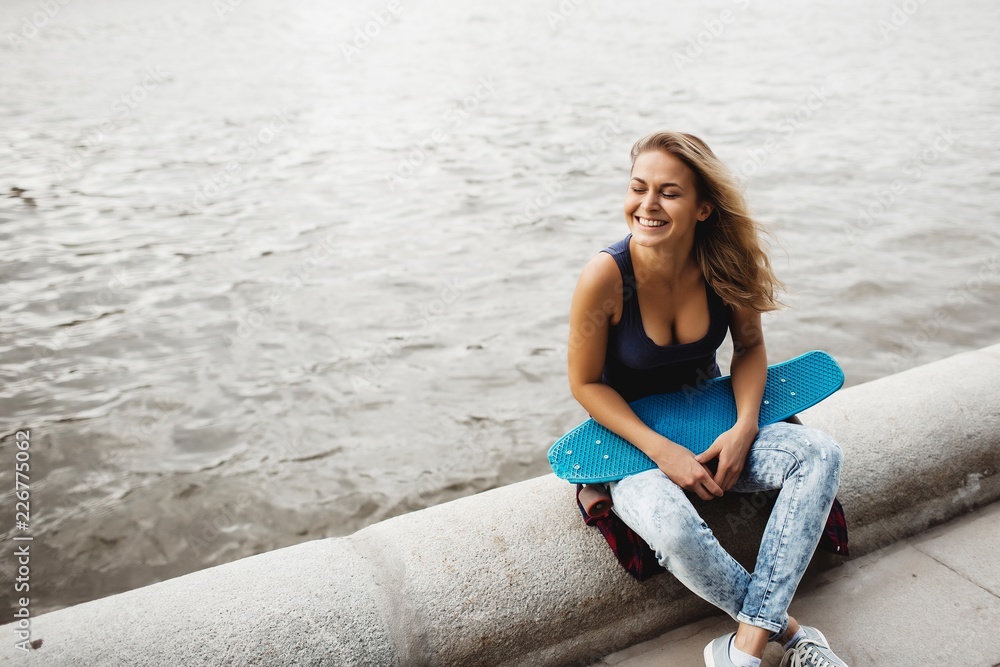 girl posing with skate board