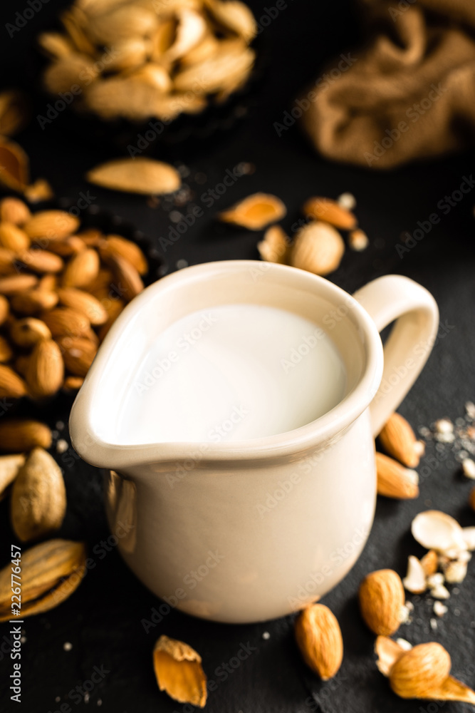 Homemade almond milk in jug. Almond milk and almonds Homemade almond milk in jug. Almond milk and almonds