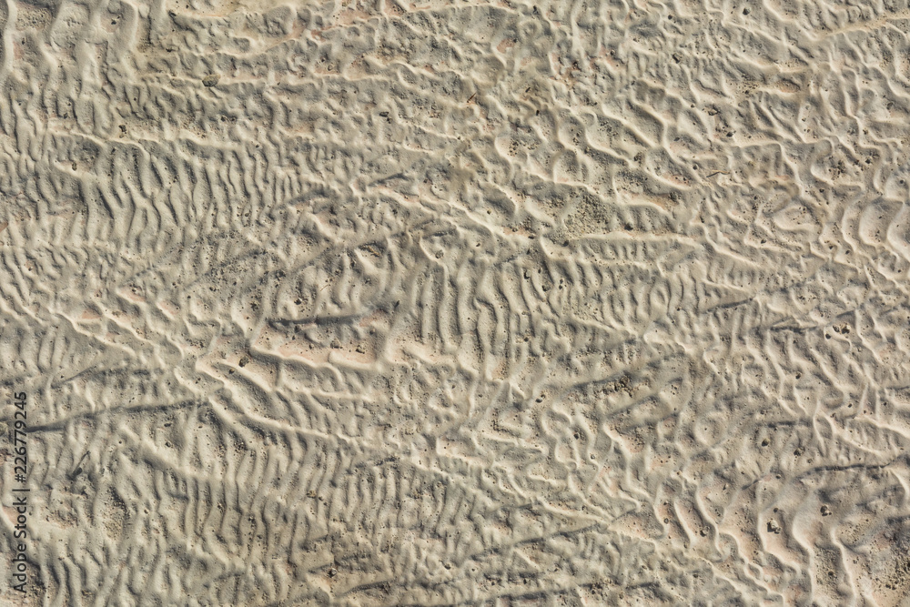 The surface of the limestone in the form of intricate patterns. The texture is made by flowing water for many years in Turkish Pamukalle. An interesting natural phenomenon. The surface of the limestone in the form of intricate patterns. The texture is made by flowing water for many years in Turkish Pamukalle. An interesting natural phenomenon.