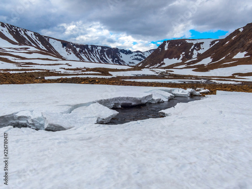 Beautiful mountain landscape, panorama. Snowy peak. Mountain river. Polar urals mountains. Yamal