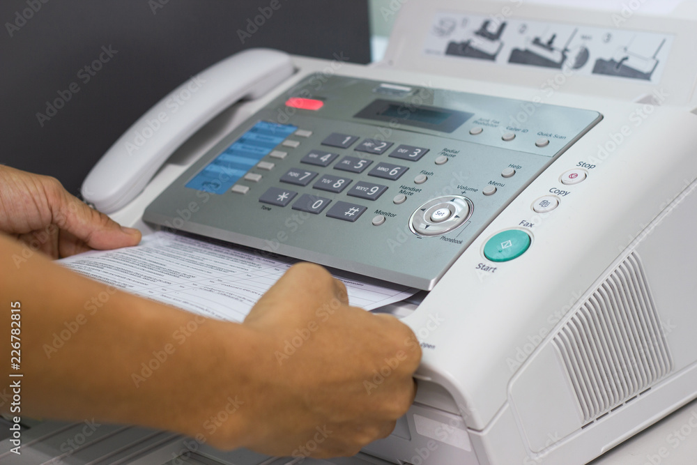 hand man are using a fax machine in the office Business concept office life hand man are using a fax machine in the office Business concept office life